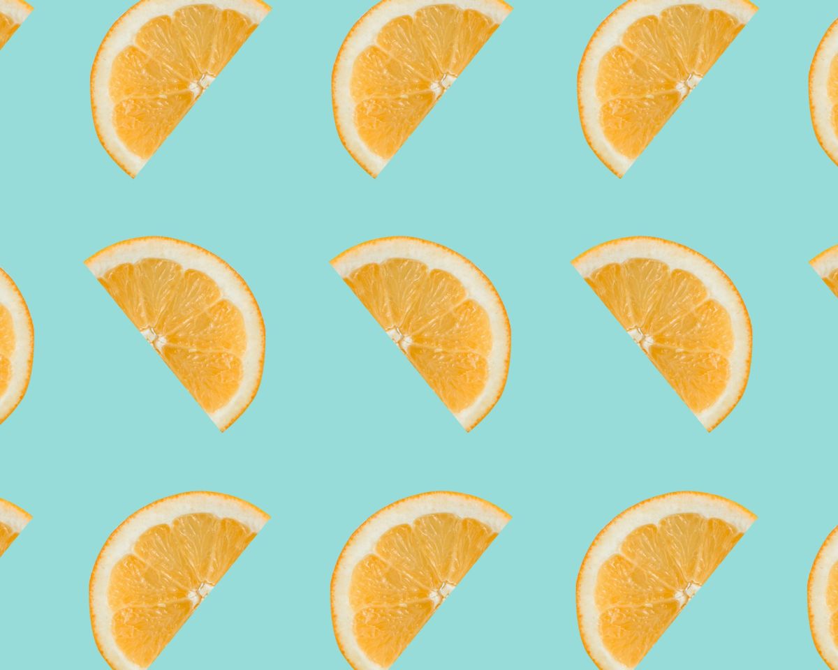 Identical orange slices repeated on a blue background